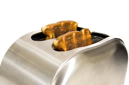 A shiny electric toaster freshly toasted bread