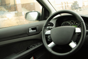 the empty driver's place in car, steering wheel closeup