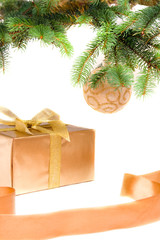 Fototapeta na wymiar christmas gift with golden ribbon under the christmas-tree