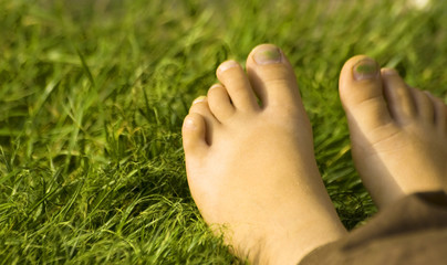 Baby feet  on the lawn