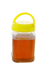 Jar of honey with lid on white background