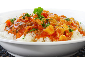 Chicken curry over steamed white rice.