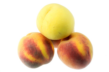 Pyramid of peaches on white.
