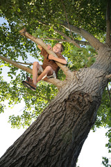 happy youth high up in a tree