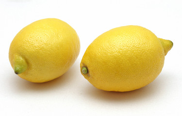 two yellow lemons on white background