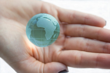 Earth globe (Africa view) in female hands. White background.