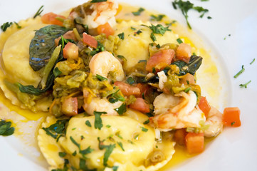 Fresh pasta ravioli filled with potatoes and seafood