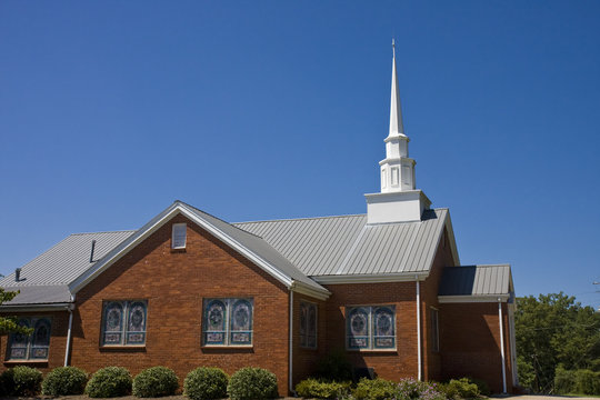 An Old Small  Brick Baptist Church And Blue Sky