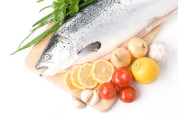 Fresh raw salmon with vegetables on a white background