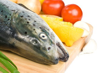 Fresh raw salmon with vegetables on a white background