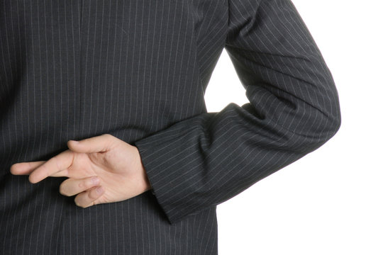 Businessman with fingers crossed behind his back. - Powered by Adobe