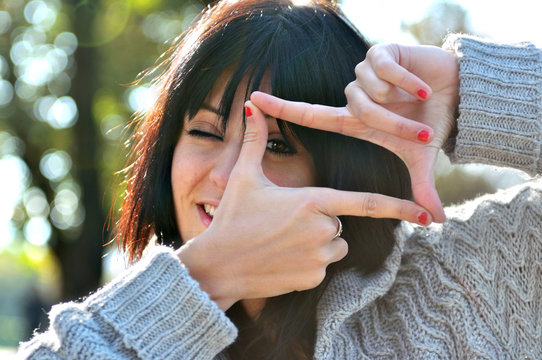 young woman pretending to see the world through a lens