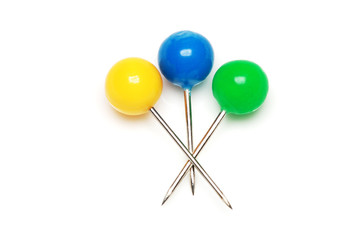 Yellow, blue and green push pins isolated on white background.
