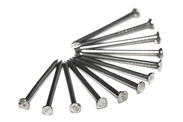 A few nails aligned in fan-shaped on white background.