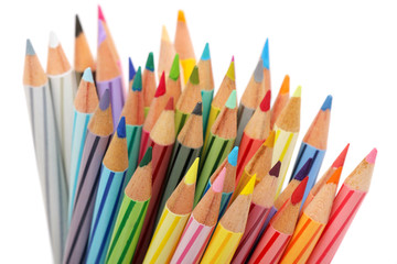 Close up of colorful color pencils over white background.