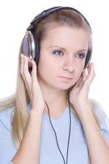 Isolated smiling young girl listening to music