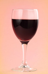 glass of red wine and gerbera flower