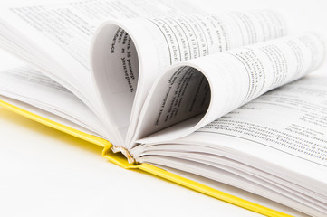 pages of a book curved into a heart shape