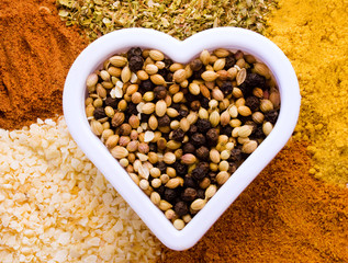 heart shape filled and surrounded by variety of spices