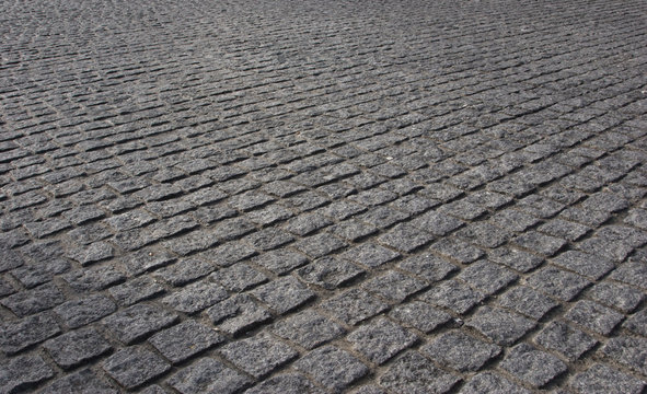 Perspective of old brick pavement with a piece of discarded gum