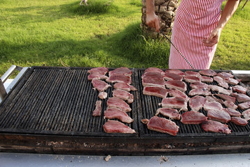 Fresh steak of tuna preparing on grill