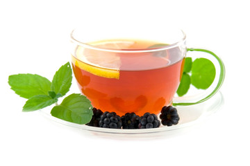 Transparent teacup with tea and lemon