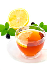 Transparent teacup with tea and lemon
