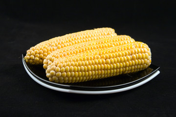 corns on a black background
