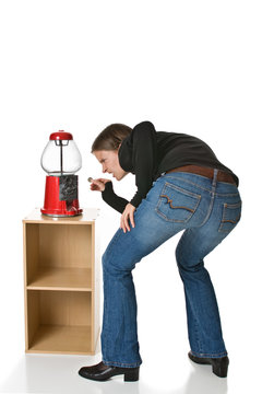 Woman Tries To Put A Quarter Into An Empty Gumball Machine.