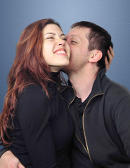 Young couple kissing, and having fun