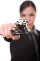 attractive brunette woman with gun on white background