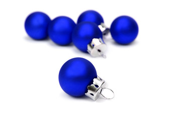 Blue christmas balls over white background.