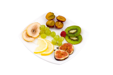 fresh fruits on a plate  isolated on a white background
