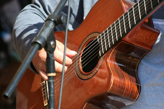 A Man playing a acoustic guitar