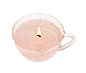 Close-up of lit candle in a glass cup