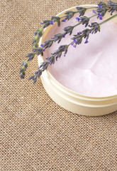 Relaxing spa scene with pink body butter in a jar