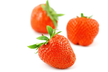 Three strawberries fruits isolated on white