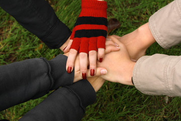 Closeup of hands held together, demonstrating unity