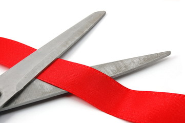 scissors and red ribbon isolated on white