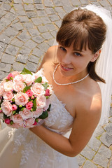 Portrait of the bride against a stone roadway