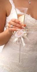 Champagne wine glass in a hand of the bride