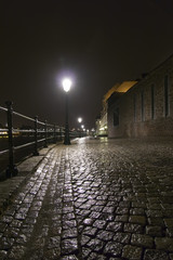 Night shot of wet cobblestone road in Maastricht, Netherland.