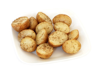 Roasted  potatoes with rosemary on a plate isolated on white