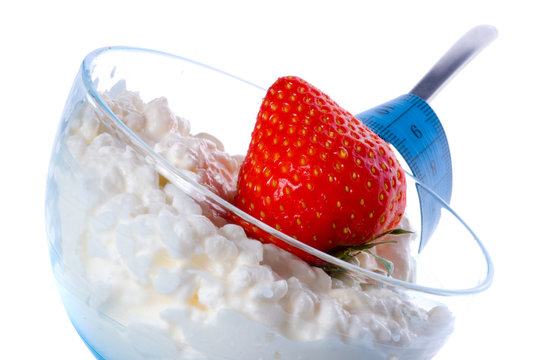 Cottage cheese in  glass with cream and berries