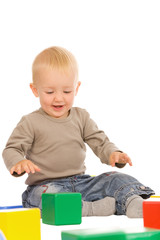 little boy play with bricks. isolated on a white background