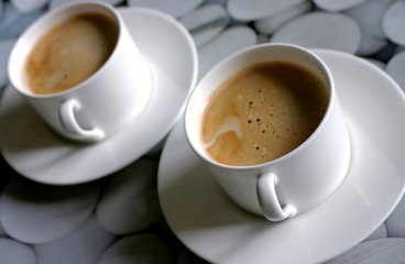 Two coffee cups full of tasty coffee