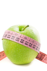Green apple and tape measure isolated on a white