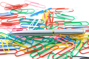 Pen over color fasteners isolated on white background