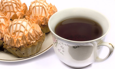 Cup of tea and cakes on a plate on a white background