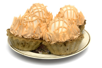 Four cake with a zephyr on a plate isolated